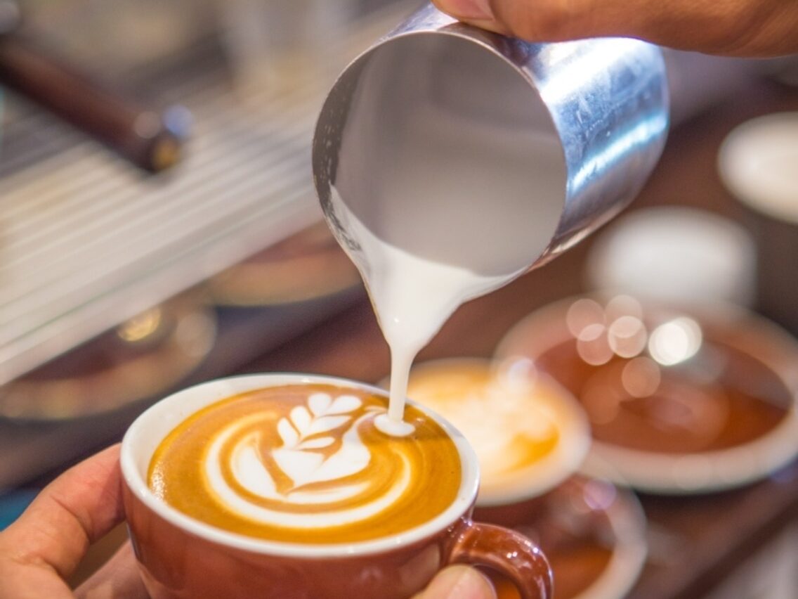 Wellington pouring milk making coffee art
